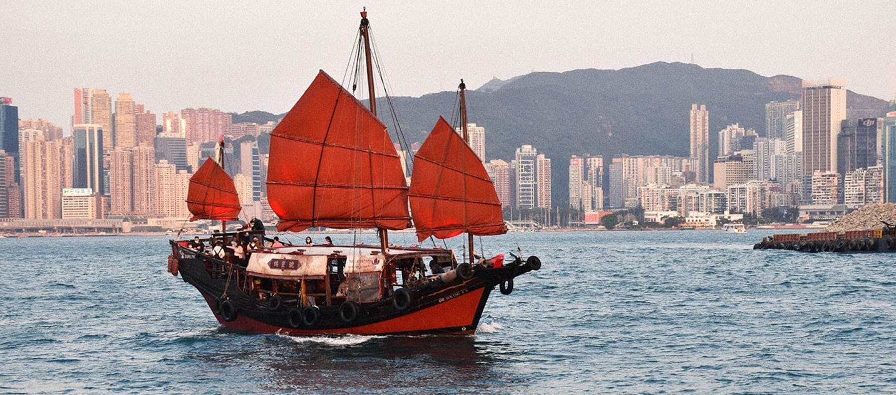 A red junk boat sailing in the sea in Hong Kong